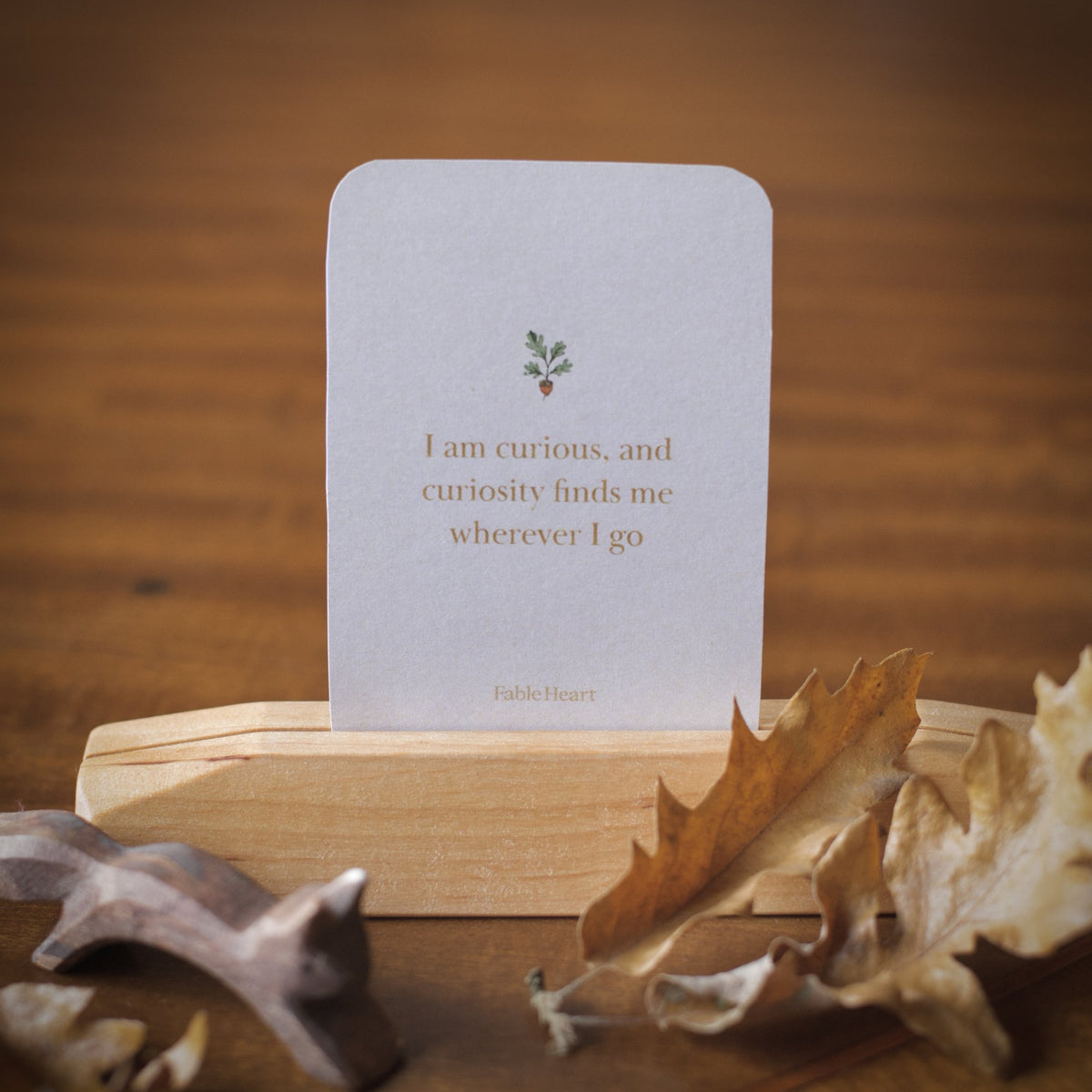 Autumn affirmation card, I am curious and curiosity finds me wherever I go, on a wooden stand