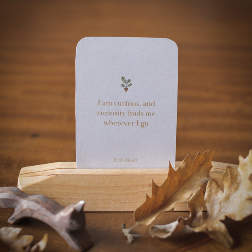 Autumn affirmation card, I am curious and curiosity finds me wherever I go, on a wooden stand