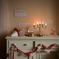 Movie Night signs, tickets and popcorn on a candlelit sideboard