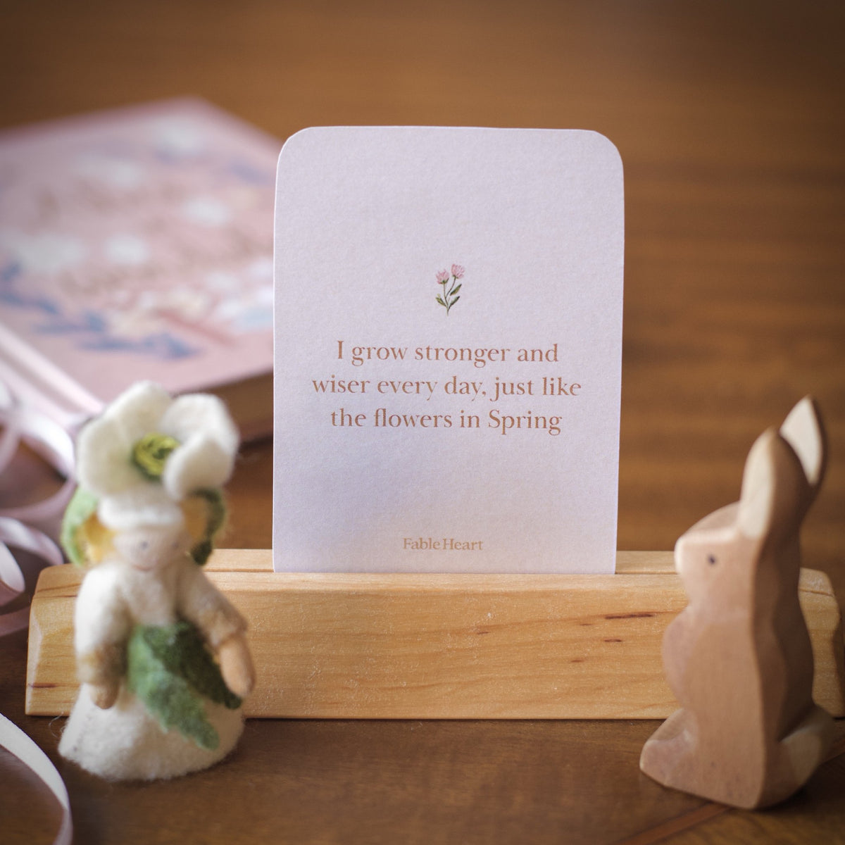 Spring affirmation card, I grow stronger, on a wooden stand