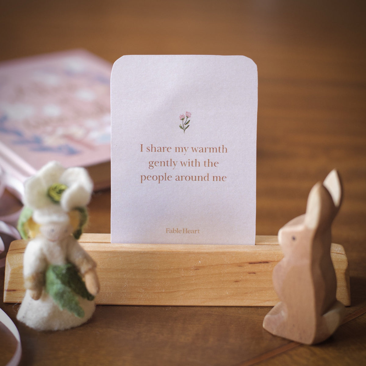 Spring affirmation card, I share my warmth gently with the people around me, on a wooden stand