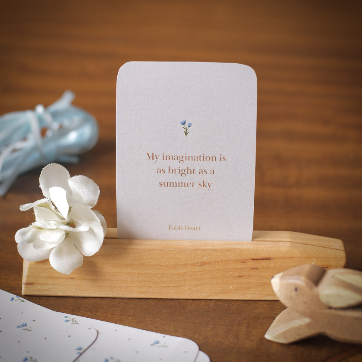 Summer affirmation card, My imagination is as bright as a summer sky, on a wooden stand