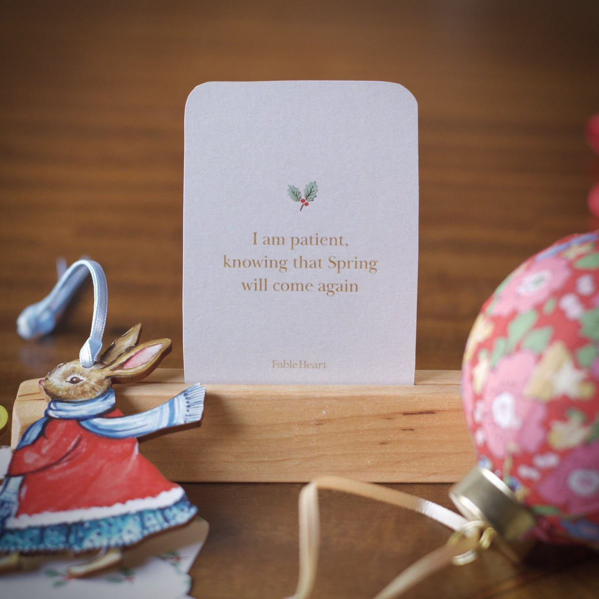 Winter affirmation card, I am patient knowing that spring will come again, on a wooden stand