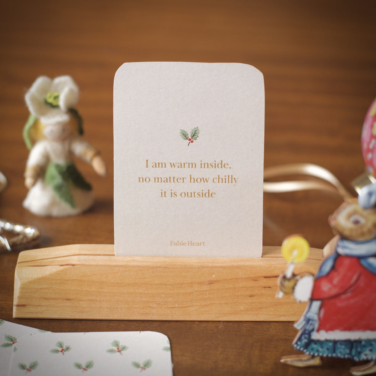 Winter affirmation card, I am warm inside no matter how chilly it is outside, on a wooden stand